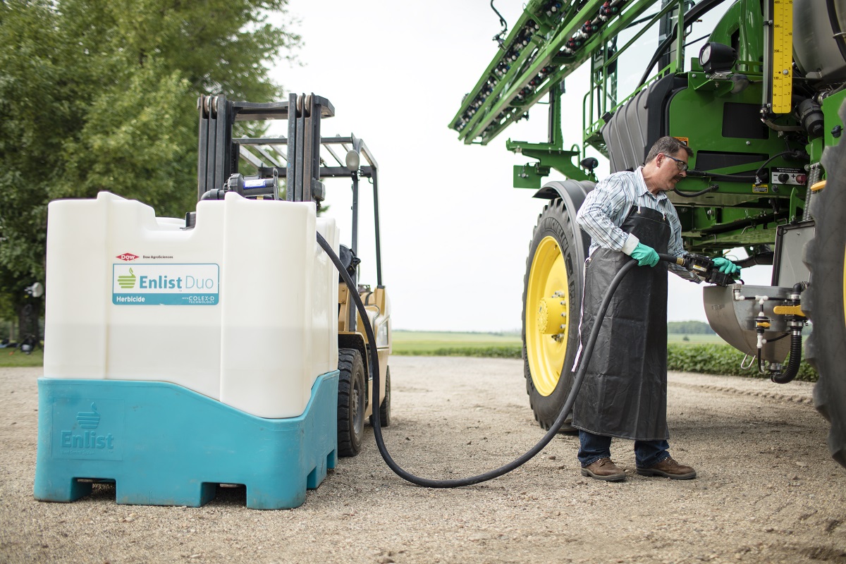 Farmer filling sprayer with Enlist Duo